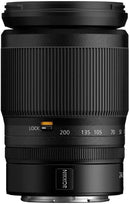 ide view of Nikon NIKKOR Z 24-200mm f/4-6.3 VR lens displaying the orange zoom lock switch, NIKKOR branding plate, and tactile control ring