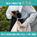 Photographer holding a black Nikon Z camera with NIKKOR Z 35mm f1.4 lens mounted